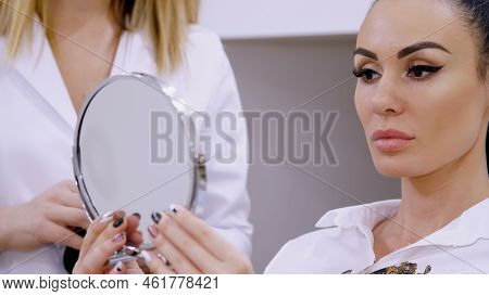 Clinic, Cosmetology Room, The Doctor Submits A Mirror To The Patient, Discusses The Procedure Of Lip