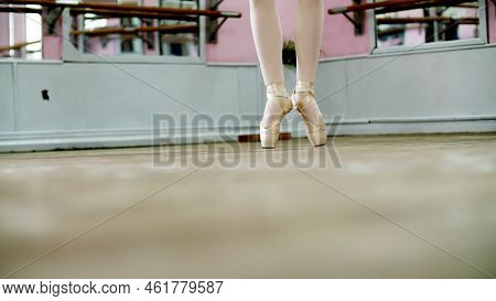 Close Up, In Dancing Hall, Ballerina Perform Ssissonne Simples , She Is Standing On Toes In Pointe S