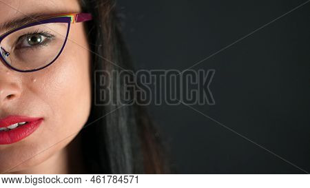 Portrait Of A Sexy Brunette Woman With Red Lips Who Eroticly And Playfully Tries On Stylish Glasses,