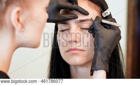 Beauty Saloon. Close-up, Hands Of The Cosmetician In Black Rubber Gloves Hold Tweezers And Pull Out 