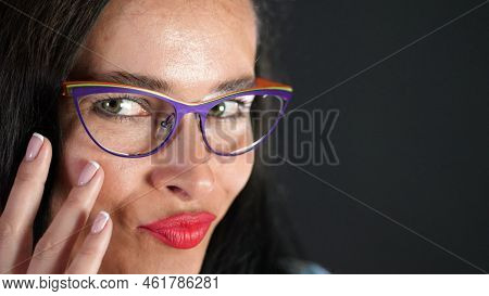 Portrait Of A Sexy Brunette Woman With Red Lips Who Eroticly And Playfully Tries On Stylish Glasses,