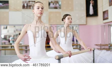 In The Ballet Hall, Two Girls In White Ballet Tutu, Packs Are Engaged At The Ballet, Rehearse Turnin