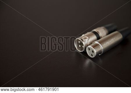 Xlr Audio Cable On Top Of A Black Table. Connections On Display. Xlr Cable Concept. Audio Concept.