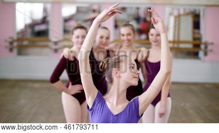 Portrait Of A Young Girl Ballet Dancer In A Lilac Ballet Leotard, Smiling, Gracefully Performing A B