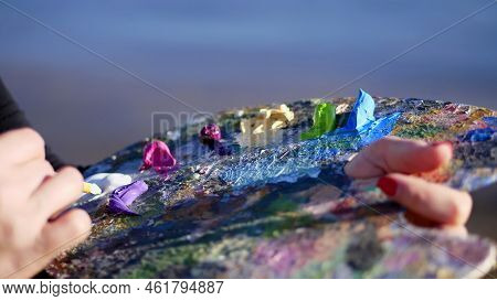 Summer, Outdoors, Close-up Of Female Hands Of The Artist And A Palette With Paints, The Artist Mixes