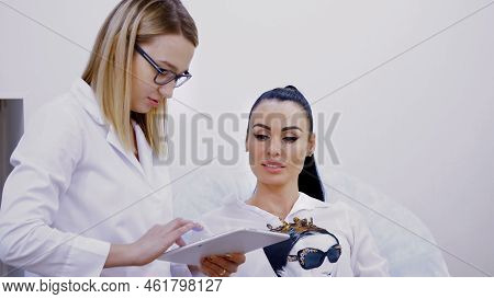 Cosmetology Room, Two Young Beautiful Women, A Doctor And A Patient Discuss Various Cosmetic Procedu