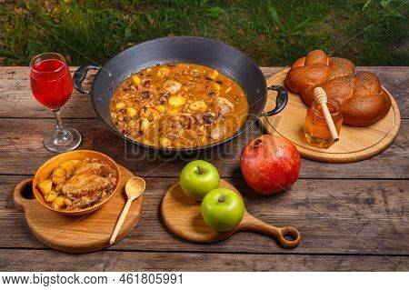 Festive Table For Rosh Hashanah Cholent With Chicken, Pomegranate, Wine, Honey, Apples, Challah.