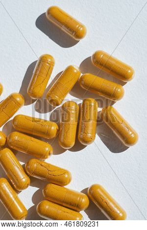 Turmeric Plus Black Pepper Extract Gelatin Capsules Close Up Top View. Herbal Supplement Organic Cur