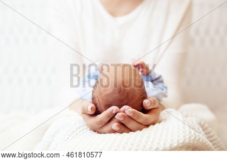 Baby Head In Mother Hands. Mum Holding Newborn Boy Lying On White Blanket. Infant Health Care And De