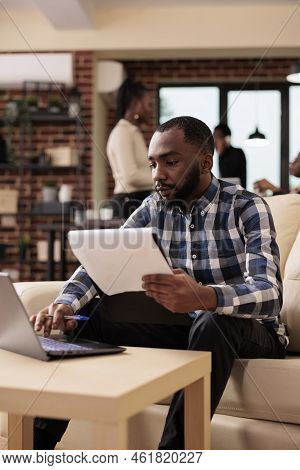 African American Freelancer Planning Paperwork In Company Office, Analyzing Data On Documets And Lap