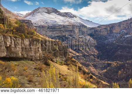 Fantastic High Rocks. Autumn Landscape With Steep Mountain Peaks In Snow. Caucasus Mountains In Guni