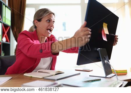 Businesswoman Screaming Hysterically At Computer Monitor In Office. Shocked Woman Financial Mistake 
