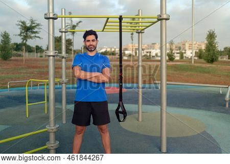 Portrait Of Confident Man Doing Fitness Exercises On A Special Hanging Device