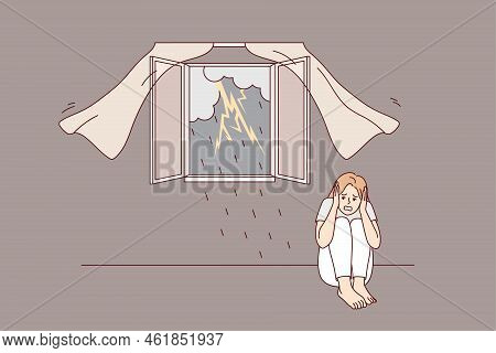 Scared Girl Sitting On Floor Afraid Of Storm Outdoors. Terrified Young Woman Feel Stressed And Frigh