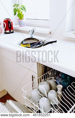 Filled Sink And Dishwasher Dirty Dishes In Kitchen With White Facades. Concept Of Repairing Home App