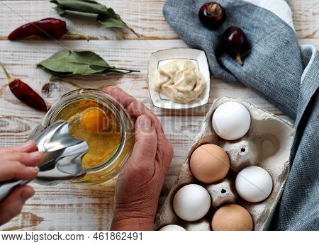 An Elderly Woman Prepares Homemade Mayonnaise From Natural Healthy Ingredients.a Jar With Vegetable 