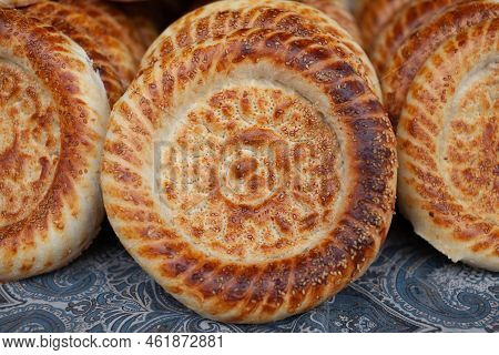 Typical Traditional Flatbread With Crunchy Crust With Sesam Just Baked In Tandoor On Market Display 