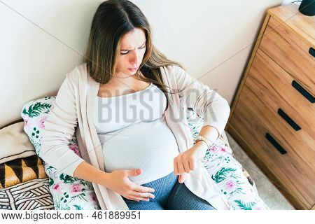 Pregnancy Contractions Time. Childbirth Time, Contractions Pain. Pregnant Holding Baby Belly, Woman 