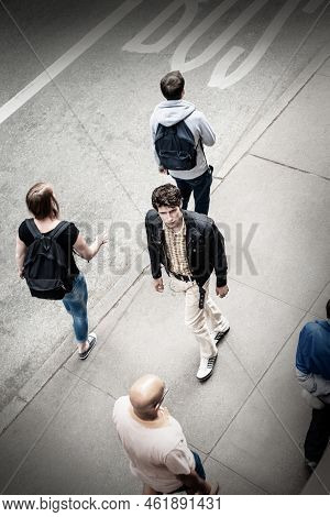 Young European Man, Wearing Black Jacket, Light Color Pants, Walking On Sidewalk On Street In New Yo