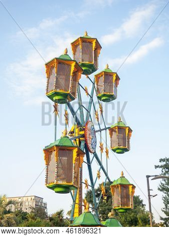 A Small Ferris Wheel In The Park. A Bright Attraction For Children. Entertainment In The Park. Color