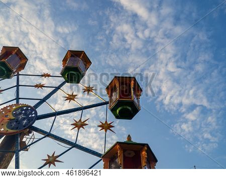 A Small Ferris Wheel In The Park. A Bright Attraction For Children. Entertainment In The Park. Color