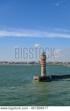 Europe, France, Dunkerque - July 9, 2022: Feu De Saint Pol Light Tower At Entrance To Port Under Blu