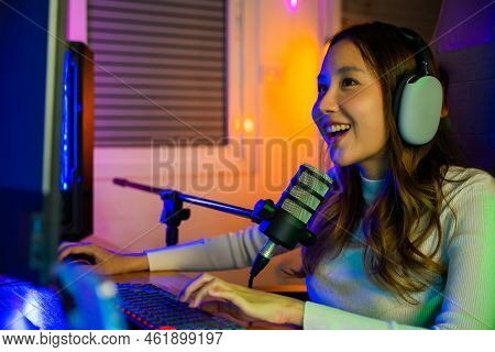 Asian Young Gamer Woman Wear Headphones Playing Video Games Online On Computer She Live Stream And C