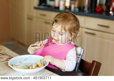 Adorable Baby Girl Eating From Spoon Mashed Vegetables And Puree. Food, Child, Feeding And People Co