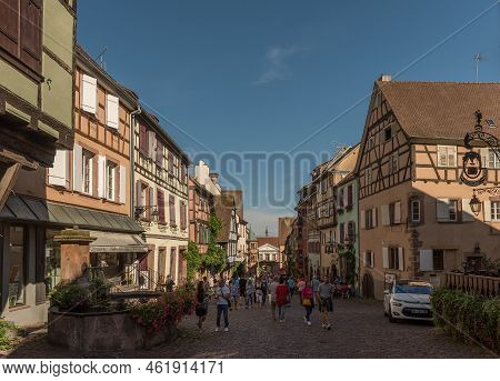 People On Street In Medieval Village Of Riquewihr, Alsace, France