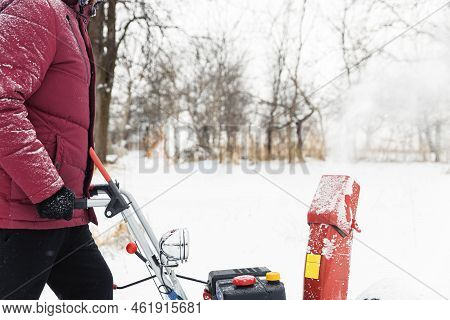 Detail Of Portable Red Snow Blower Powered By Gasoline In Action. Man Outdoor Using Snowblower Machi