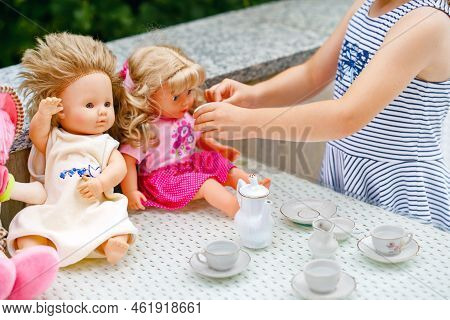 Little Preschool Girl Playing With Dolls. Happy Excited Child Play Tea Party With Toys. Role Games F
