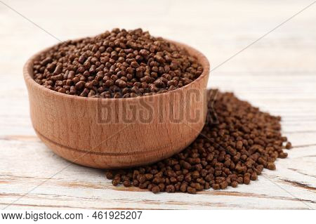 Bowl With Buckwheat Tea Granules On White Wooden Table, Closeup