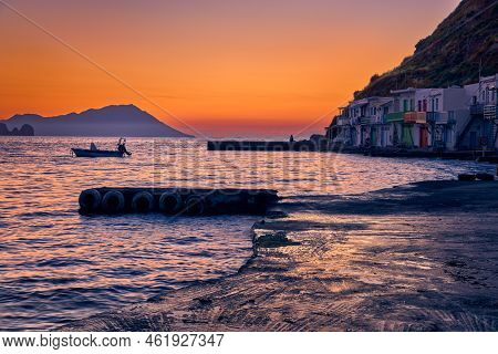 Sunset In Fishermen Village Of Klima, Milos Island, Greece. Single Adult Enjoy Sunset View On Pier O