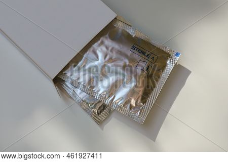 Package With Single Dose Eye Drops On White Table, Above View