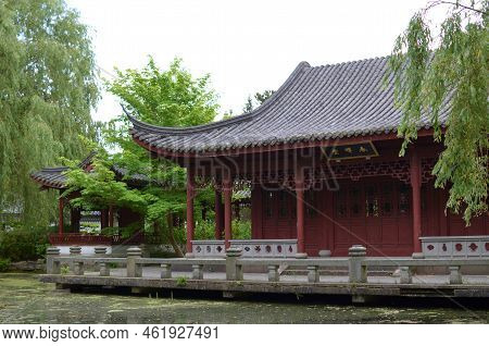 Haren, Netherlands - May 23, 2022: Beautiful View Of Oriental Building Near Pond In Chinese Garden