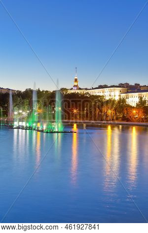 Colorful Illuminated Fountains On The Svisloch River During Summer Night Against Blue Sky Night View