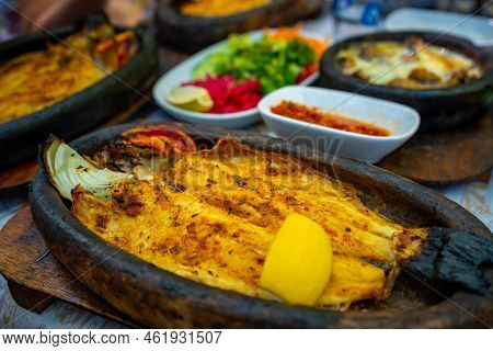 Fish Dish In Tropic Restaurants On The River. Places On The River With Tourists In Forest, Turkey