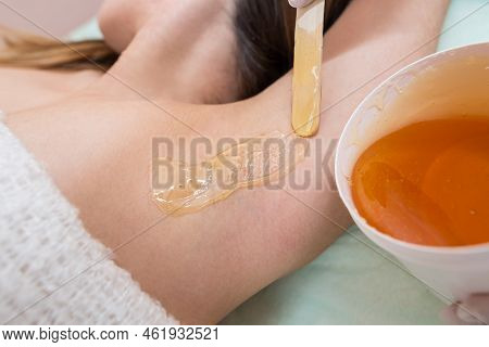 Depilation And Epilation Female Armpit With Liquid Sugar Paste By Spatula. Hand Of Cosmetologist App