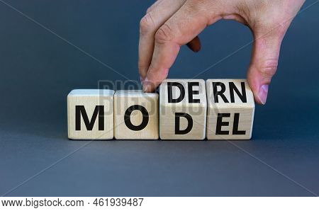 Modern Model Symbol. Businessman Turns Wooden Cubes And Changes The Word 'model' To 'modern'. Beauti