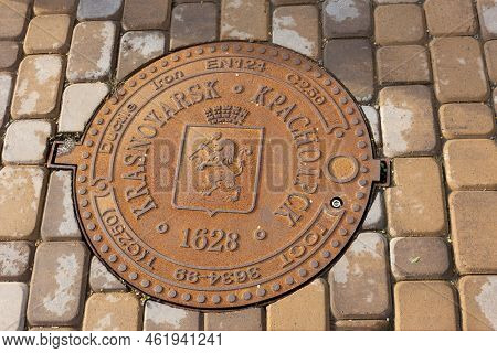 Krasnoyarsk, Russia - August 25, 2022: New Ductile Iron Manhole Cover With The Coat Of Arms Of The C