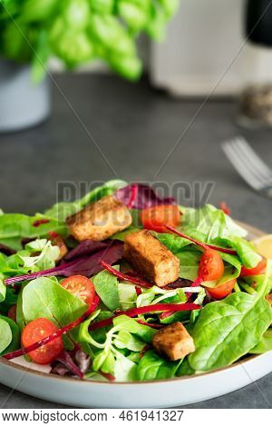 Healthy Salad With Roasted Tempeh, Cherry Tomatos, Beetroot Straws, Spinash And Lettuce Leaves On Pl