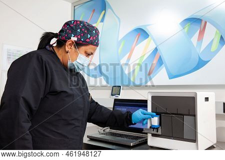 Female Scientist Working At The Laboratory With A Thermal Cycler. Polymerase Chain Reaction Techniqu