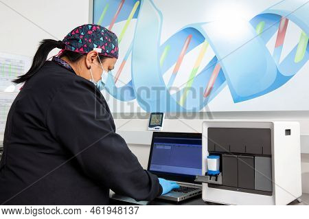 Female Scientist Working At The Laboratory With A Thermal Cycler. Polymerase Chain Reaction Techniqu