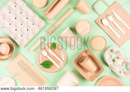 Eco Tableware Bundle, Paper Utensils, Paper Bag And Holders, Wooden Cutlery Set Over Light Green Bac