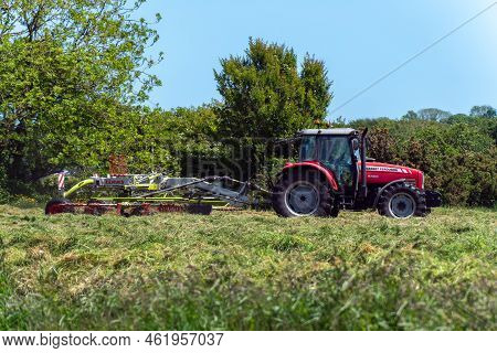 West Cork, Ireland, May 28, 2022. A Tractor Harvests Hay For Animal. Agricultural Work On Forage Har