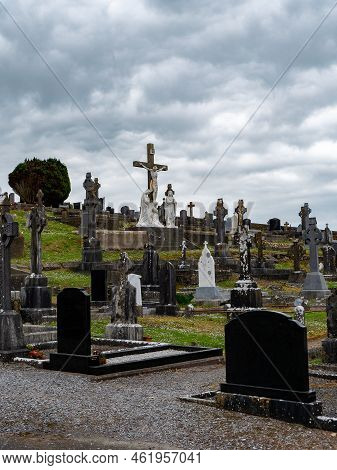West Cork, Ireland, May 2, 2022. An Catholic Cemetery On A Cloudy Day. Stone Tombstones. Cemetery Of