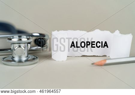 Medical Concept. On A Gray Background, A Stethoscope, A Pencil And A Paper Plate With The Inscriptio