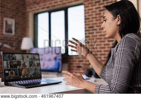 Indian Freelancer Attending Online Videocall Meeting With Colleagues On Webcam, Talking To People On