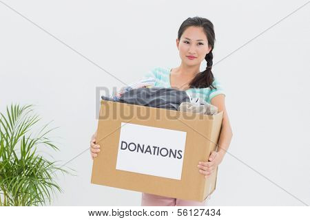 Portrait of a young woman with clothes donation