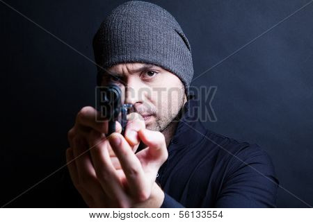 Portrait of a man holding gun